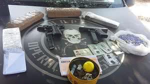 Pistolas e drogas foram apreendidas com os suspeitos. | Divulgação PM